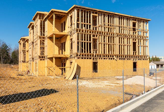 a temporary chain link fence locking away a building under renovation, serving as a security tool in Azle, TX